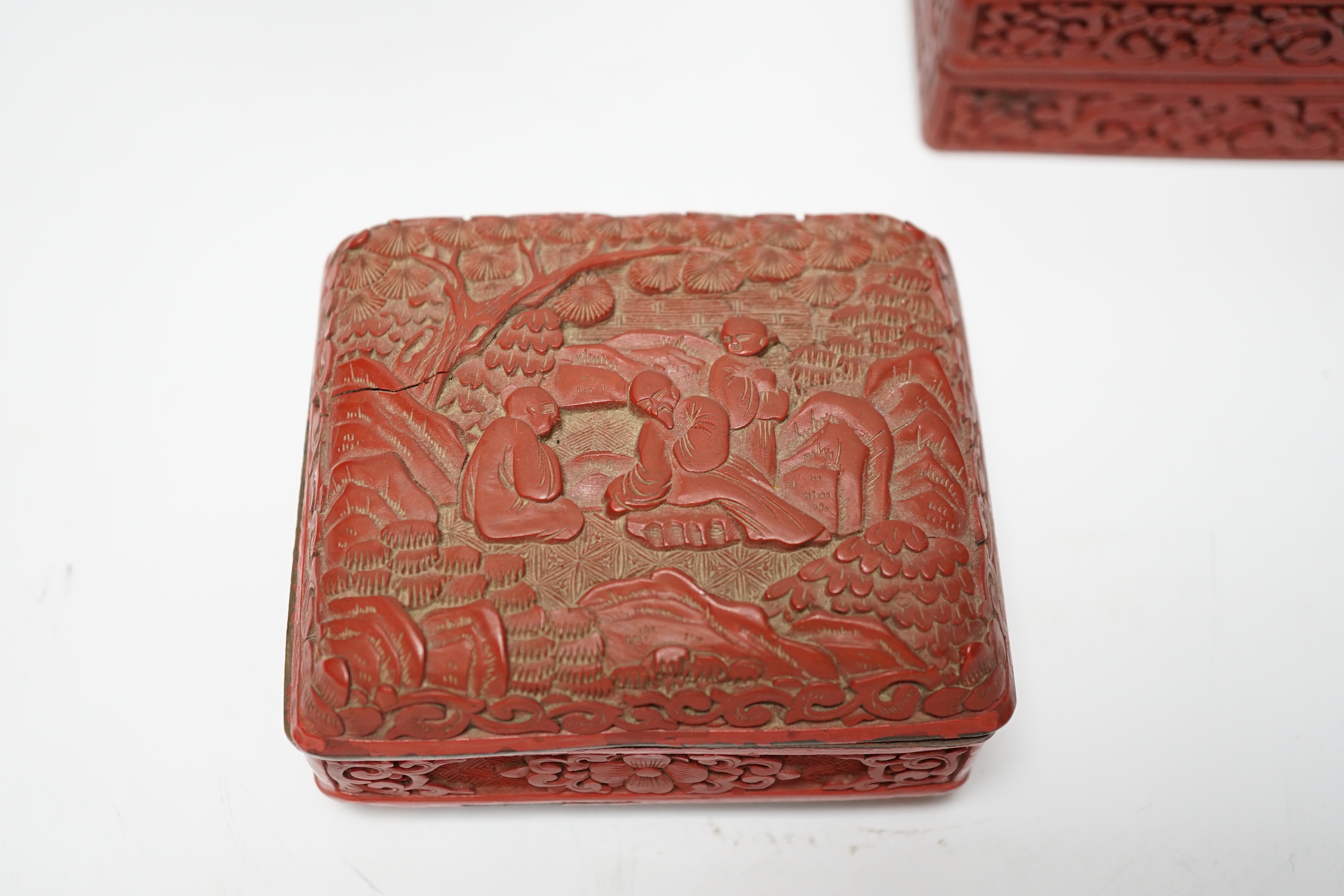 Two Chinese cinnabar lacquer boxes and a similar bowl on hardwood stand